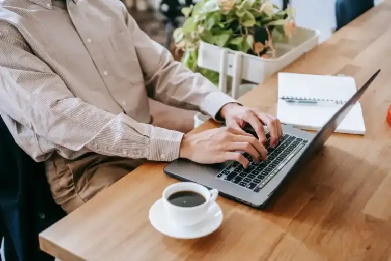 a person typing on a laptop